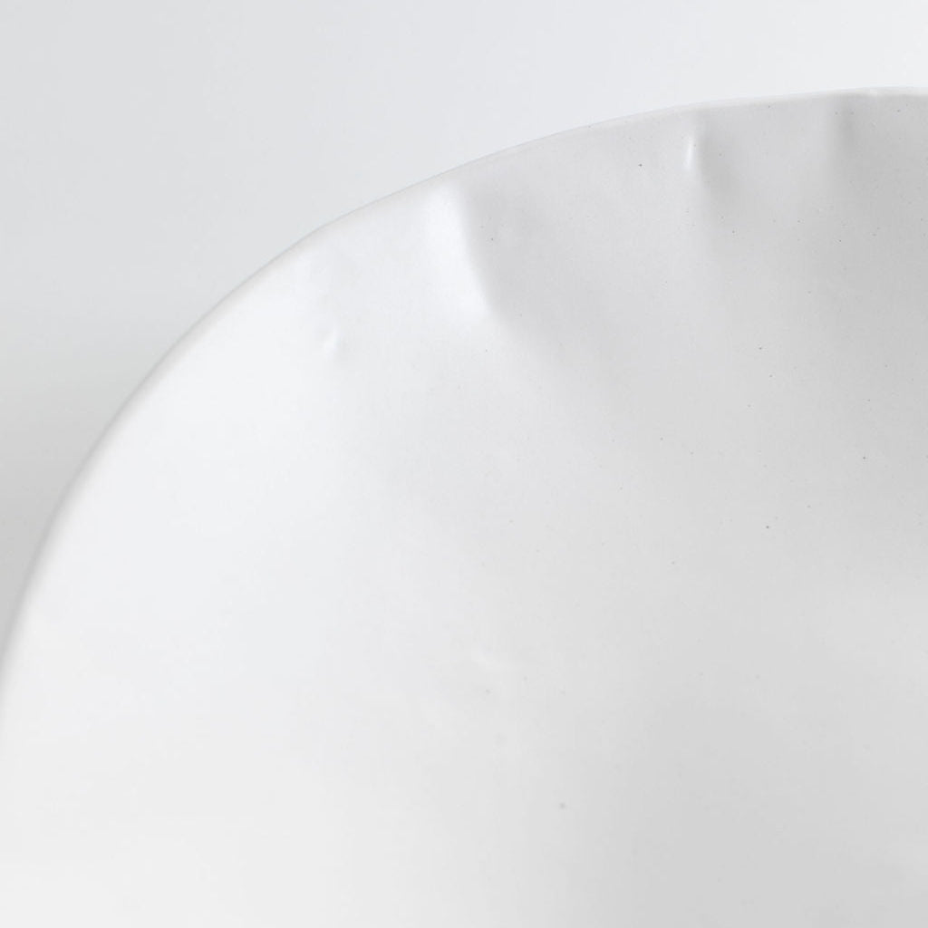 Rim close-up: Close-up of a White Matte serving bowl showing its smooth glazed interior and softly undulating rim.