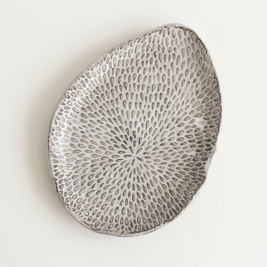 Single Petal Palette appetizer plate with botanical texture on a porcelain-white background.