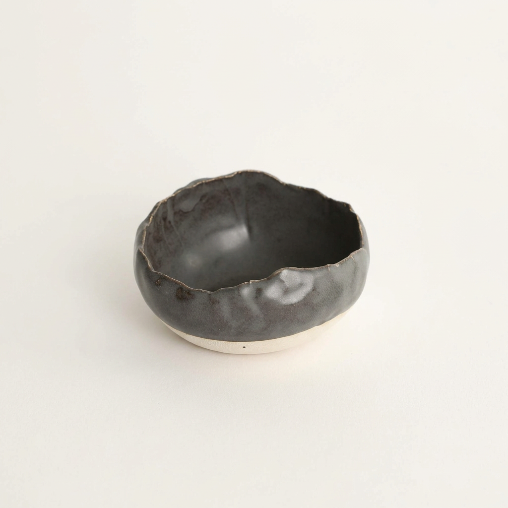Charcoal Shino handmade spice bowl on a porcelain-white background.