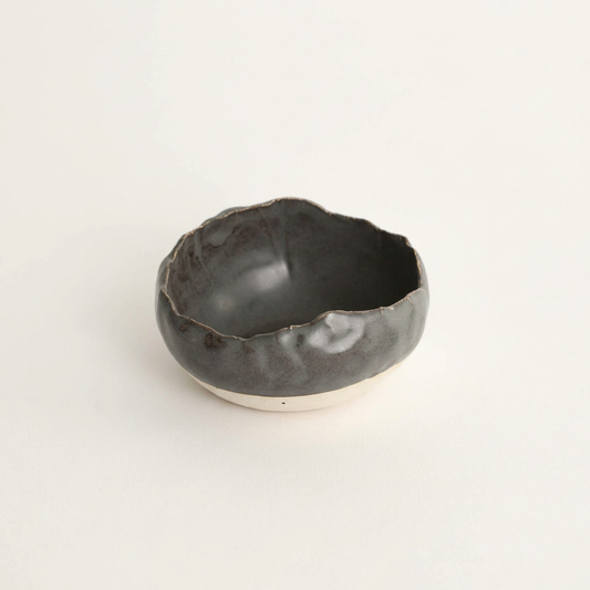 Charcoal Shino handmade spice bowl on a porcelain-white background.