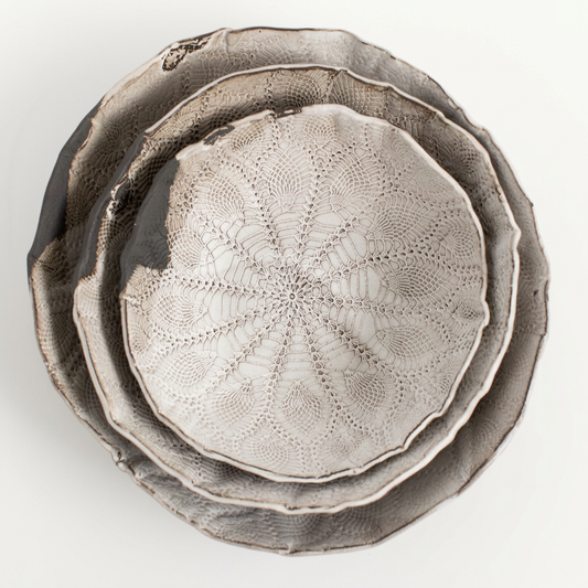 Three nested Boheme lace-textured ceramic bowls on a porcelain-white background.
